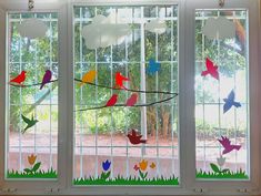 three stained glass windows with colorful birds on them