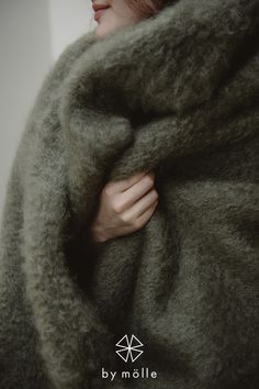 a woman is wrapped up in a blanket