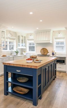 a large kitchen island with two plates on it and an oven in the center area