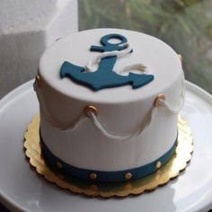 a white and blue cake with an anchor on it