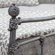 an iron bed frame with decorative designs on it