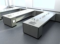 an empty office cubicle with two sinks and one desk in the middle is shown