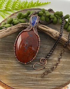 Red Moss Agate & blue lapis Copper Wire Wrap Necklace, Pendant, Free Domestic Shipping, Weavers Roots Jewelry, Christmas, patriotic   ~ copper wire is sculpted, oxidized and polished into a one of a kind gemstone setting ~ these incredible red moss agate and blue lapis gemstones, must be seen to truly appreciate the beautiful blend of red harmony in this stone🌿 ~ copper chain in your choice of length, custom lengths available ~ handmade with skill in the USA ~ I take great care in designing eac Handmade Oval Lapis Lazuli Necklace, Blue Carnelian Spiritual Jewelry, Spiritual Blue Carnelian Jewelry, Blue Carnelian Jewelry As A Gift, Blue Carnelian Jewelry For Gifting, Blue Carnelian Jewelry For Gift, Blue Carnelian Jewelry Gift, Handmade Blue Carnelian Jewelry, Red Moss Agate