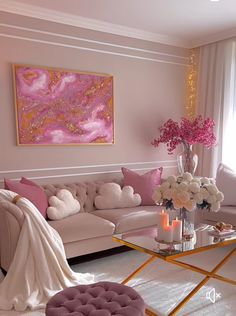 a living room filled with furniture and a large painting on the wall above it's glass coffee table