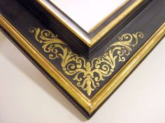 a black and gold framed mirror on the wall