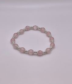 This is a Beaded Bracelet that adjusts to any size wrist.  Rose Quartz round beads with silver spacers Single layer - 7.5 inch Elastic Bracelet This is a Beautiful Elastic style Bracelet. This Bracelet wrap 7.5 inches around your wrist and is a great piece to add to your jewelry collection. beads are about 8mm. You will receive a nylon gift bag for your gift giving. You will choose gift bag color at checkout. If you have any questions send me a message. Elastic Bracelet, Minneapolis, Fashion Bracelets, Round Beads, Beaded Bracelet, Friendship Bracelets, Gift Bag, Rose Quartz, Jewelry Collection