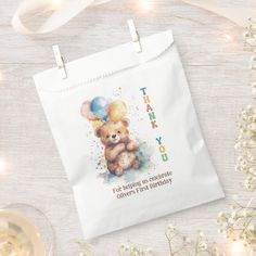 a thank you bag with a teddy bear holding balloons