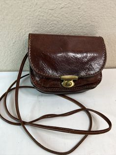 The Bridge Brown Leather Crossbody Shoulder Bag Satchel Handbag Purse. See pictures for measurements No odors Many pictures to show details No odors Cute little crossbody Good used condition Small Brown Leather Purse, Brown Cross Body Bag, Retro Brown Shoulder Bag With Mobile Phone Holder, Retro Leather Phone Bag, Retro Leather Mobile Phone Bag, Classic Pouch Shoulder Bag With Mobile Phone Holder, Classic Shoulder Bag With Mobile Phone Pouch, Vintage Rectangular Flap Bag With Mobile Phone Holder, Vintage Rectangular Flap Bag With Mobile Phone Bag