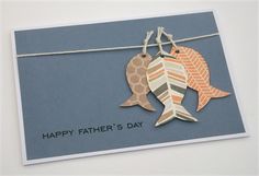 a father's day card with two fish hanging from a string