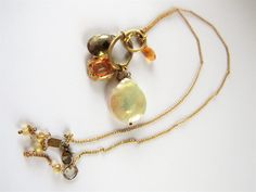 "Wow. This is a gorgeous 925 sterling (gold tone) ALEXIS BITTAR necklace with pearl, topaz and citrine. The \"pendant\" is actually a grouping of charms.  The pearl is about 5/8\" in diameter - will be seen. The shortest length is 15\" - choker size, but the chain is adjustable by hooking behind the small gems on the portion that hangs. The longest length is 19\". In very good condition - no damage. Thanks for looking. https://vintageoak.etsy.com" Gold Citrine Necklaces With Gemstone Accents, Gold Citrine Necklace With Gemstone Accents, Unique Gold Citrine Necklace, Hippie Necklace, Wedding Jewellery Necklace, Pearl Gemstone, Alexis Bittar, Necklace Vintage, Quartz Pendant