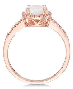 Magical shine. Indulge in this sophisticated piece, featuring round-cut opal (3/4 ct. t.w.) surrounded by sparkling diamonds (1/8 ct. t.w.). Ring set in 14k rose gold. Elegant White Rings From Macy's, Elegant Macy's Rings For Anniversary, Macy's Diamond Ring With Diamond Accents, Elegant 14k Gold Rings From Macy's, Macy's Round Diamond Ring With Diamond Accents, Macy's Wedding Jewelry With Prong Setting, Macy's Prong Setting Wedding Jewelry, Elegant Formal Rings From Macy's, Macy's Classic Diamond White Ring