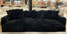 a couch made out of black velvet in a furniture store