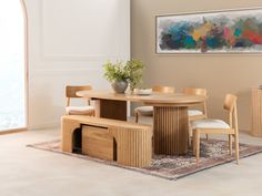 a dining room table and chairs with a vase on the end shelf next to it