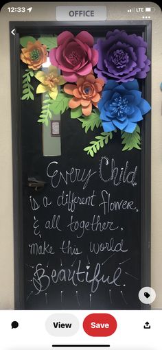 an office door decorated with paper flowers and writing