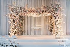 a wedding ceremony setup with white chairs and flowers