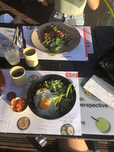 a person sitting at a table with food and drinks