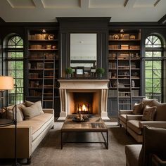 a living room filled with furniture and a fire place in the middle of a room