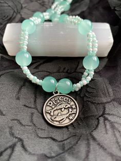 "Hello Pisces peeps! This is the final necklace in my zodiac collection and it's my absolute favorite! The piece is made with the Pisces power color seafoam green. This color connects to several Pisces qualities including imagination, selflessness, and compassion. On this pendant, the first side features little fish while the other has the Pisces symbol and the word \"intuitive\". Thank you for visiting the Market of Mischief and I hope to see you again soon!" Pisces Symbol, Pisces Bracelet, Sagittarius Necklace, Pisces Necklace, See You Again Soon, Zodiac Collection, Power Colors, See You Again, Seafoam Green