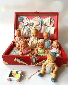 a red box filled with lots of little dolls