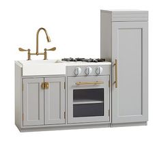 a white kitchen with an oven, sink and faucet