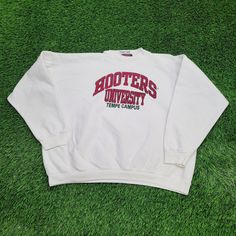 Vintage Hooters University Sweatshirt Womens 2XL 24x25 Tempe Show your Hooters pride with this vintage Hooters University sweatshirt, 2XL, from Tempe. Perfect for retro style lovers!  * Used condition  * Length is on the shorter side  * No rips/holes  * Stains (see picture and zoom in to see size/location)  * Normal fading from washing  * Normal cracking on the graphic VINTAGE HOOTERS SWEATSHIRT, HOOTERS UNIVERSITY, WOMEN'S 2XL SWEATSHIRT, TEMPE HOOTERS, RETRO HOOTERS GEAR, 2XL VINTAGE SWEATSHIRT, HOOTERS COLLEGE WEAR, VINTAGE HOOTERS TEMPE, WOMEN'S RETRO SWEATSHIRT, HOOTERS FASHION #VintageSweatshirt, #HootersUniversity, #TempeHooters, #2XLClothing, #RetroFashion, #HootersGear, #VintageHooters, #CollegeSweatshirt, #WomensVintage, #RetroSweatshirt 75212 Vintage Embroidered College Top, Vintage Embroidered Graphic Top For College, Vintage Embroidered Graphics Top, Vintage Embroidered Tops For College, Vintage Cotton Sweatshirt With Lettering, Vintage Cotton Sweatshirt For Campus, Vintage Pre-shrunk Sweatshirt For Fan Merchandise, Pre-shrunk Vintage Sweatshirt For Fans, Vintage Pre-shrunk Sweatshirt For Fans