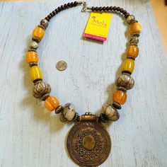 Get ready to add a pop of color to your outfit with this stunning Mela Chunky Glass Bead Brass Medallion Necklace. The necklace is made of high-quality brass metal and features a beautiful multicolor beaded design, making it a perfect accessory to wear on any occasion. With a 24-inch necklace length, it sits perfectly on your neck, giving you a comfortable and stylish look. Whether you're dressing up or down, this Mela necklace is sure to impress. Antique Jewelry Art, Opalite Necklace, Shell Beads Necklace, Antique Jewelry Necklace, Blue Beaded Necklace, Fairy Necklace, Charm Necklace Silver, Purple Rhinestone, Medallion Necklace