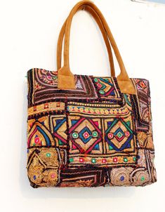 This bohemian banjara bag is the perfect accessory for the bohemian fashionistas. Key Features: Hand made in India. Fair trade guaranteed. Zipper top. Inside zipper pocket. Size ( Approx ) Height - 12 Inches/30 Cm. Width - 15 Inches/38 Cm. Handle Length 10 inches/ 25 Cm.  Inside Pocket - 3 ( As you can see in the picture ) Zipper Pocket - 1 Made from vintage Banjara  mirror work embroidery, it's a strong bag, and the perfect size for all your essential everyday stuff and more.... You'll get a look with a fashionable element of boho, and it will also team beautifully with your classic pieces. A bag for all seasons, and a bag that compliments a variety of looks is a very handy thing to have....it's a design I've been using myself for years, and can highly recommend! Material: 100% Cotton Ban Rectangular Hobo Bag For Everyday Use And Festivals, Rectangular Multicolor Embroidery Bag For Festivals, Handmade Multicolor Bags For Festivals, Multicolor Handmade Bags For Festivals, Handmade Multicolor Festival Bags, Handmade Tote Shoulder Bag For Festivals, Multicolor Shoulder Bag For Festivals, Embroidered Rectangular Shoulder Bag For Festivals, Embroidered Rectangular Bags For Festivals