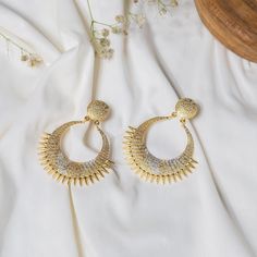 Define beauty and elegance with these Unique and Designer Handmade Gold & Silver Dangle Earrings. The earrings are finely crafted with a round stud and an ethnic dangler. The earrings are plated in dual-tone (gold and silver) and have a beautiful texture. These are just perfect for any special occasion or a happy day! Details: Brass Metal Gold & Silver Plating Handmade Dangle/Drop Earrings Ethnic Earrings Hypoallergenic Nickel & Lead-free Elegant Chandbali Crystal Earrings For Party, Metal Dangle Chandbalis For Pierced Ears, Metal Chandbalis For Pierced Ears With Dangle Design, Elegant Pierced Danglers For Party, Gold Bridal Earrings With Elegant Design For Party, Elegant Gold Bridal Earrings For Party, Elegant Pierced Party Danglers, Gold Metal Earrings For Wedding, Pierced Round Chandelier Earrings For Wedding