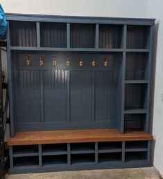 a room with some shelves and benches in it