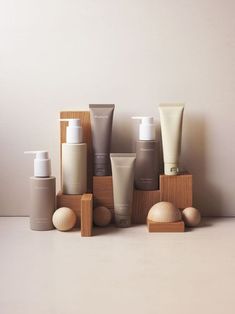 several different types of skin care products sitting on top of each other in front of a white wall