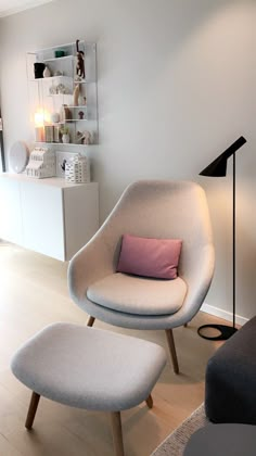 an egg chair and ottoman in a living room