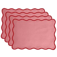 three pink placemats with scalloped edges