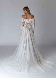 the back of a wedding dress with long sleeves and an off - shoulder lace top