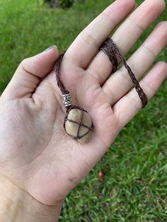 Genuine, River Rock Necklace ~ unique, natural stone necklace with a braided hemp cord!   These handmade necklaces have been created with genuine river rocks that have been sustainably collected from various rivers throughout the foothills of Alberta, Canada. By ensuring that we never take too many rocks from the same area and always leaving the areas where we collect as we found them, we prevent the degradation of the wild places that are so important for our local ecosystems and species.  Every rock is unique with its own set of characteristics, ranging from colour to natural cracks within the stone, making each piece truly one-of-a-kind! No rock has been altered in any way, but is exactly as it was when it was found, to allow for the most natural look as possible. A thin layer of resin Hand Strung Necklaces, River Rock Necklace, Natural Stone Jewelry Necklace, Rock Necklace Diy, Natural Stone Jewelry Diy, Seaglass Ideas, Hemp Cord Necklace, Rock Crafts Diy, Resin Spray