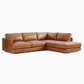 a brown leather sectional couch on a white background