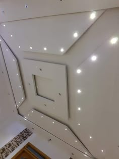 an overhead view of the ceiling in a building with white lights on it's sides