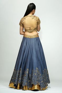 Gold blouse with gota, sequin and glass bead work embroidered motifs. Paired with bluish grey lehenga and dupatta.
Components:3
Pattern:Embroidered
Type of Work:Sequin, bead
Neckline:Round
Sleeve Length:Short
Fabric:Net, raw silk, organza
Color:Blue,Grey
Other Details:
Cutwork detailing
Sheer dupatta
Occasion:Sangeet - Aza Fashions Fitted Embellished Dola Silk Traditional Wear, Semi-stitched Silk Lehenga With Gold Embroidery, Gold Embroidered Raw Silk Fabric For Reception, Silk Lehenga With Gold Embroidery In Traditional Drape, Semi-stitched Embellished Lehenga For Transitional Season, Silk Sets With Gold Embroidery For Reception, Transitional Semi-stitched Embellished Lehenga, Designer Chanderi Lehenga With Gold Embroidery, Fitted Raw Silk Anarkali Set With Gold Embroidery