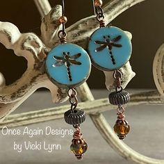 “Summer Dragon” - Dangle Earrings Hand Created - Once Again Designs By Vicki Lynn Limited Edition Fun Earrings That Feature Dragonfly Coin Beads Paired With Repurposed Vintage Textured Metal And Czech Glass Beads. This Pair: - New Czech Glass Coin Dragonfly Beads. - Repurposed Vintage Metal Beads With Textured Stripes. - Beautiful Czech Glass Bead Dangle With Lovely Turquoise Blue And Rich Brown Swirls. - Tierracast Niobium Hypoallergenic French Hook Ear Wires With Copper Bead. - Length: Just Sl Czech Beads Jewelry, Dragonfly Beads, Czech Glass Jewelry, Academia Aesthetics, Handmade Boho Jewelry, Spring Earrings, Earring Ideas, Repurposed Vintage, Artisan Earrings