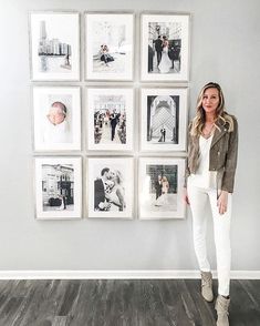 a woman standing in front of a wall with pictures hanging on it and the words instagram