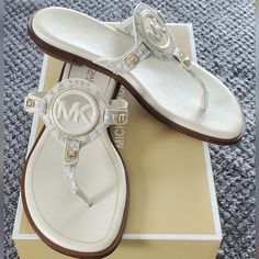 These Gorgeous Michael Kors Signature Sandals Are Vanilla In Color With Gold Hardware. Michael Kors White Leather Sandals, Michael Kors Open Toe Sandals For Vacation, Michael Kors Open Toe Sandals, Michael Kors Beach Sandals With Cushioned Footbed, Michael Kors Slip-on Sandals For Vacation, Michael Kors Flat Sandals, Mk Shoes, Cruise Trip, Ladies Footwear