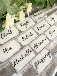 the names of people who have been married are displayed on a table with white flowers