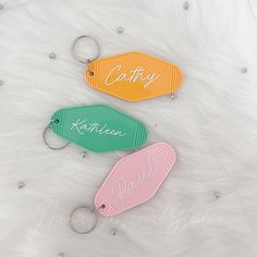 three different colored tags with the name kitty written on them