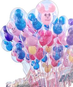 a bunch of balloons that are in the shape of mickey mouses and other disney characters