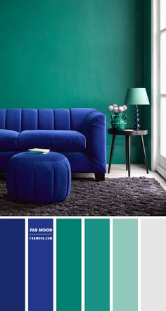 a living room with green walls and blue furniture