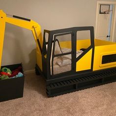 there is a yellow construction truck bed in the room