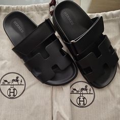 Authentic Black Leather Hermes Chypre Sandals. Women's Size 34. With Dust Bags. Brand New Never Worn. Got These As A Gift And Sadly Doesn't Fit Me. Gifter Bought At Hermes In France; I Don't Have The Receipt Or Box But As You Can See In Pics, It's Brand New Never Worn Condition. Hermes Cypress Sandals, Black Leather Slides For Evening, Evening Black Leather Slides, Formal Black Slides For Summer, Luxury Black Calf Leather Slides, Designer Black Slides For Formal Occasions, Elegant Black Slides With Branded Insole, Luxury Round Toe Slides For Formal Occasions, Luxury Black Open Toe Slides