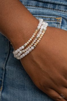 A dainty collection of icy white and iridescent crystal-like beads join mismatched silver accents along stretchy bands around the wrist, creating whimsical layers.

 Sold as one set of three bracelets. Wedding Brainstorming, White Beads Bracelet, Candy Bracelet, Beaded Jewelry Bracelets, Diy Beaded Bracelets, White Bracelet, Green Cactus, Iridescent Crystal, Beads Bracelet Design