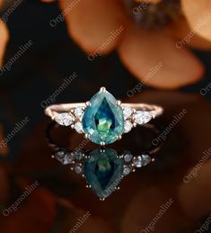 an engagement ring with a blue and green stone