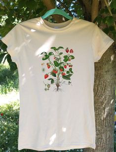 "BRAND NEW PRINTED T-SHIRT Heat transferred T-SHIRT  DESIGN:  T-shirt with botanical illustration. Printed on durable, non-shrink 100% cotton - soft to the touch and light. The designs  are all inspired by nature, art, music and culture. Our T-shirts will be a great addition to your wardrobe.  You can combine them with jeans, dress pants and various jackets for different styles.  Our designer t-shirts will be a wonderful gift for your loved ones. THE SIZE All dimensions are shown in size tables photo, please read the dimensions carefully before placing the order! YOU HAVE TO BEAR IN MIND THAT T-SHIRTS ARE \"FIT\" SIZE. IF YOU WOULD LIKE TO HAVE THEM LOOSE FIT NEED TO CONSIDER THE BIGGER SIZING.  CHECK THE SIZE CHART (IN CM), IT WILL HELP YOU CHOOSE THE SIZE. COLOURE: 100% Cotton T-shirts - Organic Short Sleeve T-shirt For Spring, Vintage Short Sleeve T-shirt With Plant Print, Organic White Short Sleeve Tops, Cotton T-shirt With Strawberry Print, Cotton Short Sleeve T-shirt With Strawberry Print, Organic White Graphic Print Tops, Organic Short Sleeve T-shirt With Screen Print, Vintage Cotton T-shirt With Plant Print, Vintage Organic Cotton Short Sleeve T-shirt