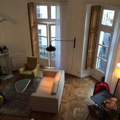 a living room filled with furniture and windows